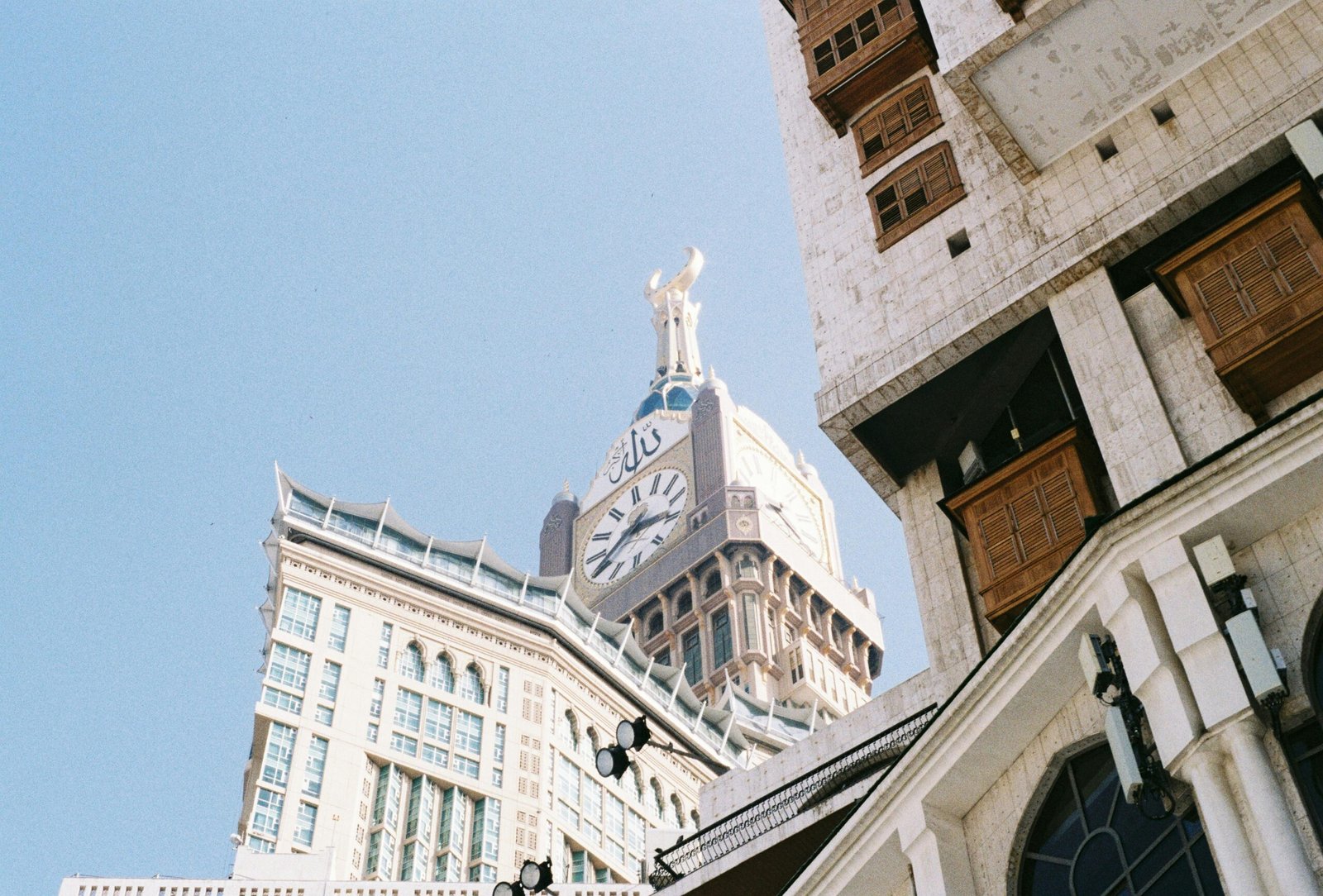 pexels-photo-31565687-31565687 A dramatic view of Abraj Al Bait Towers with intricate architecture against the clear sky in Mecca, Saudi Arabia.